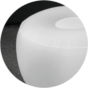 A close-up of white, inflatable furniture reveals a round chair with a smooth surface, set against a dark background. The focus is on the top and side of the chair.