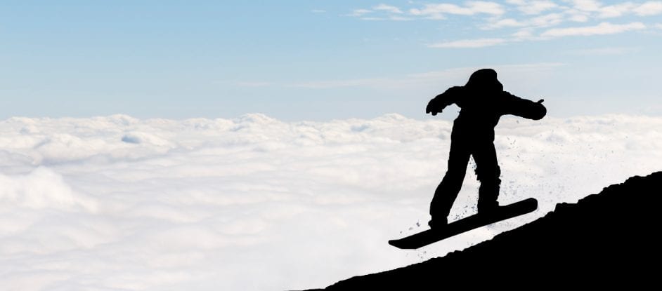 A silhouette of a snowboarder in mid-air against a backdrop of clouds and a clear blue sky, soaring above snowy slopes near colorful canopy tents, creating a dynamic and adventurous atmosphere.
