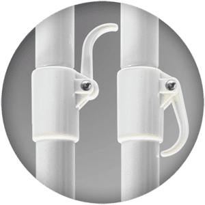 Close-up of two white plastic clamps with screws on vertical poles. The clamps have curved handles, and the background is a neutral gray.