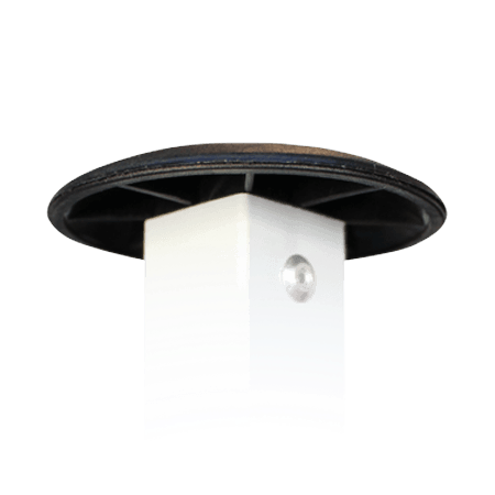Close-up of a white cylindrical object with a round black top and a small metallic button on the side, set against a plain white background.
