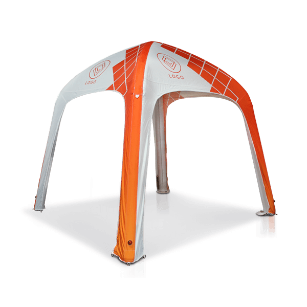 An inflatable event tent with an arch design, predominantly white with bright orange accents and geometric patterns. It has a partially visible logo at the top and open sides.