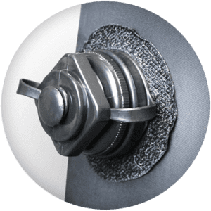 Close-up of a gray mechanical component with a hexagonal nut and metal fittings, mounted on a textured circular surface. Reminiscent of an inflatable air tower's sturdy frame, the background is slightly blurred, highlighting the detailed design and shiny finish of the hardware.