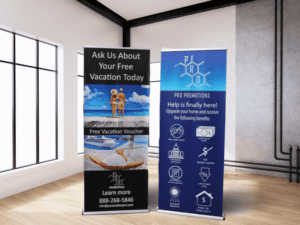 Two promotional banners on display indoors. The left banner advertises a free vacation voucher, featuring an image of a beach. The right banner highlights benefits of using Pro Promotions, with icons representing various services.