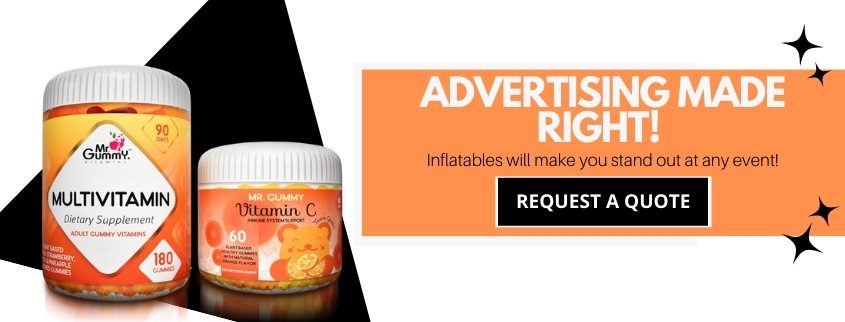Image showing two gummy vitamin bottles on the left, one labeled Multivitamin and the other Vitamin C. To the right, text reads Advertising Made Right! Inflatables will make you stand out at any event! with a Request a Quote button below.