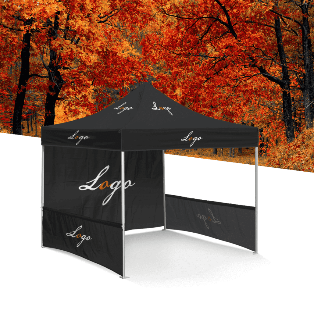 A black pop-up canopy tent, perfect for soccer events, features "Logo" elegantly scripted in white on its roof and sides. It stands against a vibrant autumn forest backdrop, where the bright red and orange leaves enhance its striking presence.
