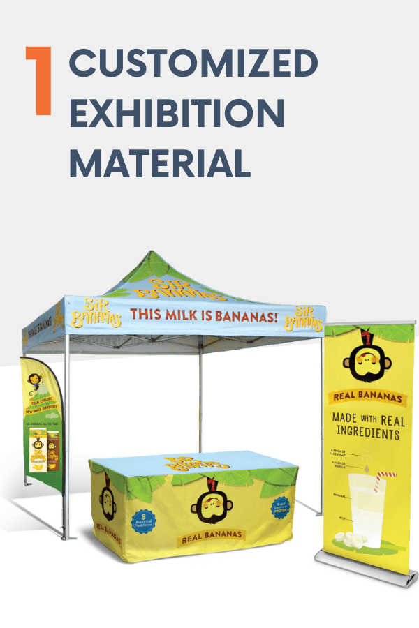 A promotional booth at trade shows featuring Sip Bananas branding includes a tent, a table covered with a banana and monkey logo, and a standing banner promoting milk crafted from real ingredients. The catchy tagline reads, This milk is bananas!