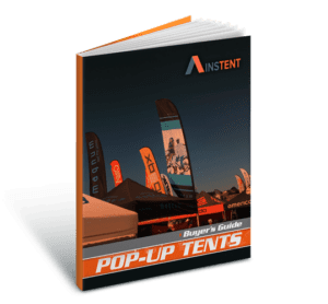 3D rendering of a pop-up tent buyers guide book. The cover shows various tents and branded flags at an outdoor event under a blue sky.