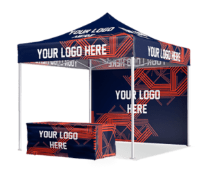 A 10'x10' Pro Plus Package canopy tent featuring a blue and orange geometric design with "Your Logo Here" printed on the fabric. In front, a matching table is covered with fabric displaying the same text and pattern.