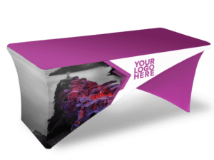 The Cross-Stretch Table Cover - Fully Printed is a fitted tablecloth in purple and white, featuring a placeholder for a logo and a design that includes an image of a coastal village on the side.