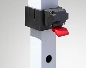 A close-up captures a white metal post with a black bracket, supporting a red lever. A small round hole pierces the post, reminiscent of sturdy frameworks found in a 10 x 10 pop up canopy tent. The background is a plain light gray, highlighting the sleek and functional design.