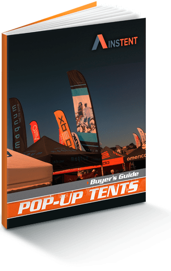 Cover of a Pop-Up Tents Buyers Guide featuring various branded 10 x 10 pop up canopy tents and flags set up outdoors against a clear blue sky.
