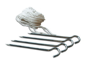 A coiled white rope alongside a set of four shiny metal tent pegs with hooks, labeled as the "Stake Kit," arranged on a plain background.
