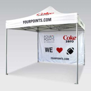 A white canopy tent featuring logos and text that reads FOURPOINTS.COM, Coke Zero, and Four Points by Sheraton. The back panel displays WE ♥ with a football image, promoting sports and drinks.