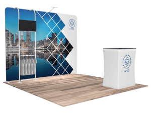 Introducing the 10'x10' Quick-N-Fit Booth - Package #1112, featuring a cityscape backdrop and geometric design. The setup includes a foreground counter displaying your logo and a TV screen elegantly mounted on a stand. The wooden flooring adds to the modern and professional ambiance of the booth.