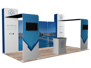 The 10'x20' Quick-N-Fit Booth - Package #1201 offers a sophisticated trade show setup with blue and white panels adorned with placeholder text and logos. It includes two sections equipped with large screen areas, a central counter featuring a logo, all set on a wood-patterned floor, complemented by backdrop images displaying a cityscape view.