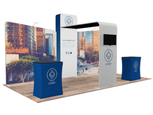 Discover the 10'x20' Quick-N-Fit Booth - Package # 1202, a trade show booth with a sleek design in blue and white. It boasts an expansive backdrop featuring an urban scene, display stands adorned with a logo, and designated space for a monitor. Additionally, it includes a counter ideal for engaging interactions or information distribution.