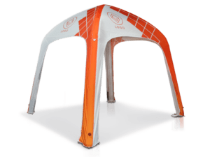 A Printed Air Tent Top featuring a geometric design in orange and white is positioned on a flat surface, supported by four arched legs with a pointed top showcasing logos on the canopy.