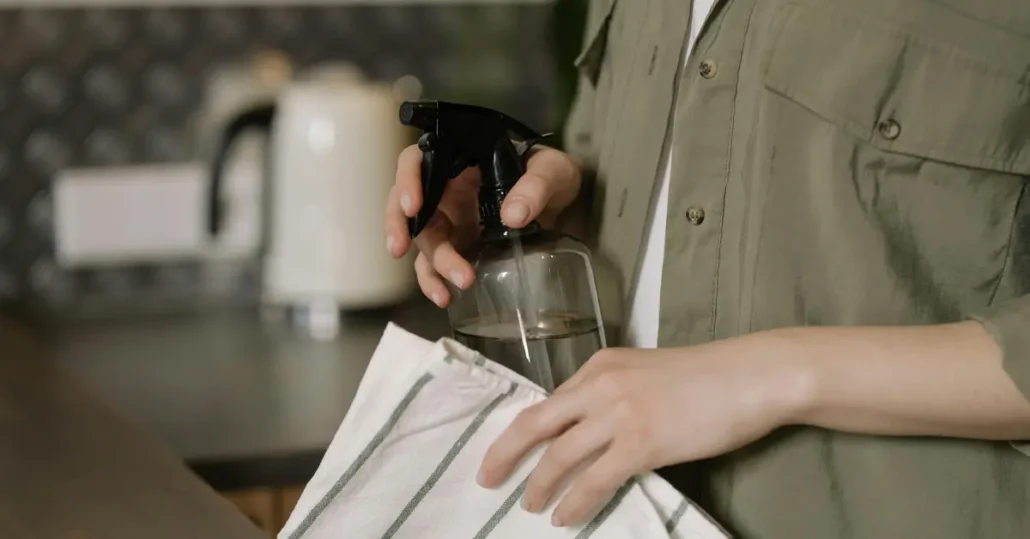 person holding spray bottle