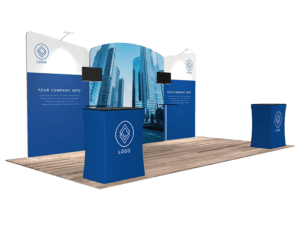 The 10'x20' Quick-N-Fit Booth - Package #1212 is a trade show setup featuring a backdrop with skyscraper imagery. It includes two smaller counters and two mounted screens, and its design incorporates a blue color scheme with panels for displaying your logo and company information.