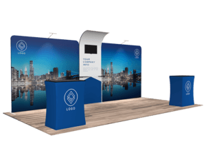 Introducing the 10'x20' Quick-N-Fit Booth - Package #1216: This trade show booth boasts a cityscape backdrop and includes a display area, a tall central counter with an attached screen, and a small table adorned with blue cloth featuring logos.