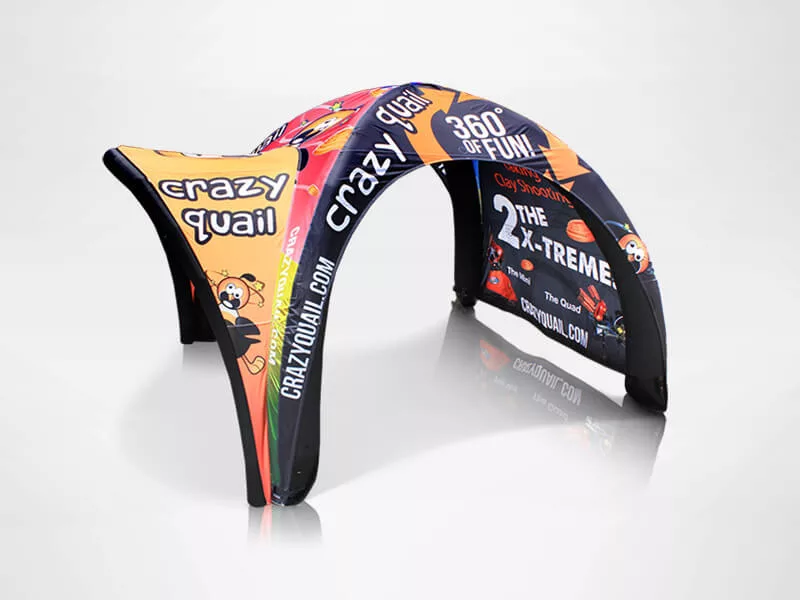 A colorful inflatable arch-shaped tent with the words Crazy Quail and 360° of Fun printed on it. The design features cartoon characters and bright colors, creating an eye-catching display on a plain white background.