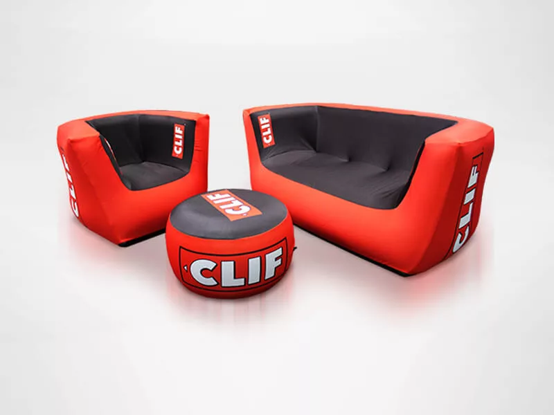 Red and black inflatable furniture set featuring CLIF branding, including a sofa, chair, and round ottoman, arranged on a white background.