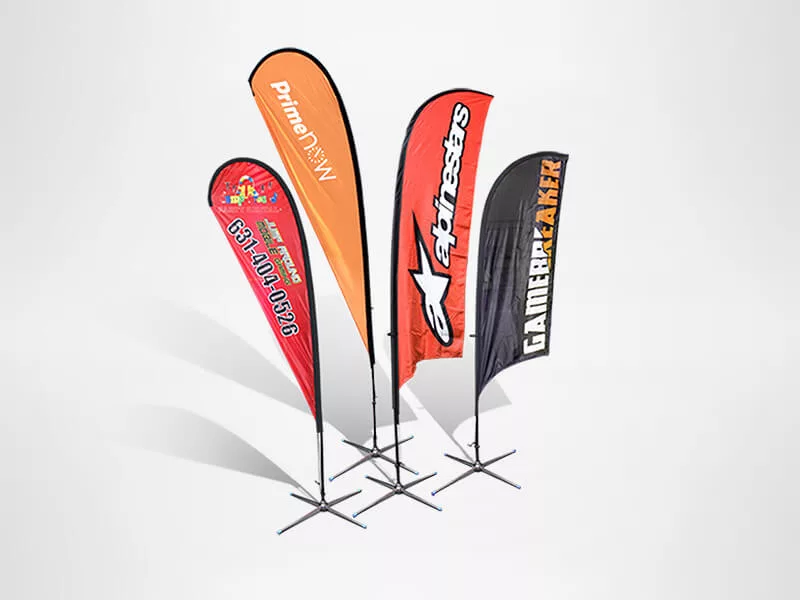 Four vertical promotional banners are displayed on stands. They are designed in bright colors with various brand logos and texts, including prime, calif, and GAMER. The banners have different shapes and are set against a plain background.