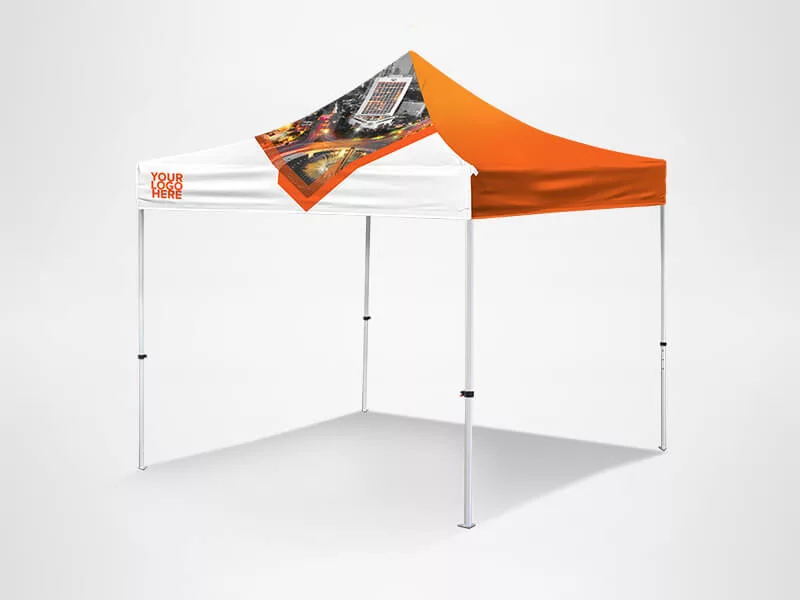 Outdoor canopy tent with a white and orange design, featuring a customizable section on the top front. The legs are metallic and the structure casts a shadow on a plain gray background.