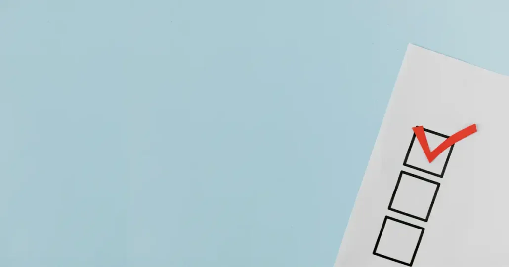A blue background with a partially visible checklist on the right. The checklist has three boxes, and the top box is marked with a red checkmark.