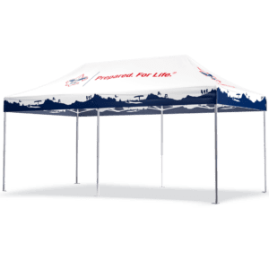 A 10’x20′ white BSA custom printed tent features tree silhouette edges and the text Prepared. For Life. on it, supported by a metal frame and set against a plain backdrop.