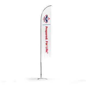 The 13ft Sunblade Flag features a logo of a blue and red fleur-de-lis atop a tall white flag, with Prepared. For Life.® printed vertically in red, mounted on a black pole with base.