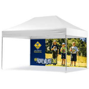 A white outdoor canopy features the Cub Scouts - 15 Tent Wall - #Adventure On! poster. It depicts three children in scout uniforms on grass with trees behind them, and includes details on joining at beascout.org.