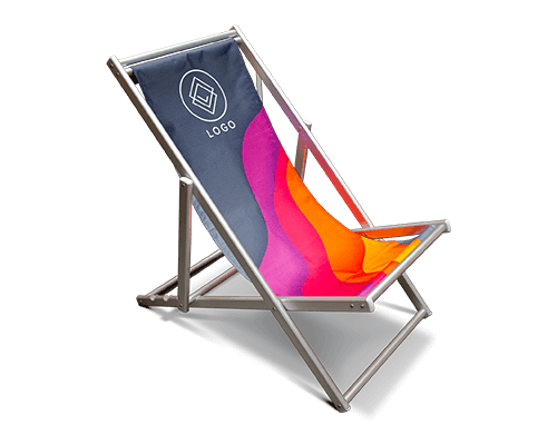 A folding deck chair with a wooden frame, featuring a fabric seat in wavy gradients of pink, orange, and dark blue, and a white logo with geometric shapes on the upper left corner.