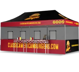 A red and black food stall tent with CLASSICAMERICANBURGERS.COM and images of burgers printed on it, featuring three service windows and a counter in front. Social media icons are displayed on the upper right corner.