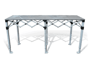 A metal folding table with a grid-pattern top and adjustable, crisscrossed support bars beneath, standing on six sturdy legs with flat, round bases.