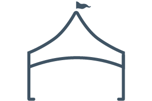 Simple line drawing of a tent with a triangular roof and a small flag at the top center. The structure has curved sides and an open front.