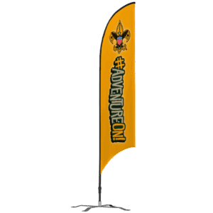 Yellow vertical flag with the Boy Scouts of America fleur-de-lis emblem at the top and the phrase #ADVENTUREON! in bold, stylized letters below, mounted on a black stand.