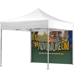 A white canopy tent with a banner showing the Boy Scouts fleur-de-lis logo, kids roasting marshmallows, and large text reading #AdventureOn! Join the adventure at beascout.org.