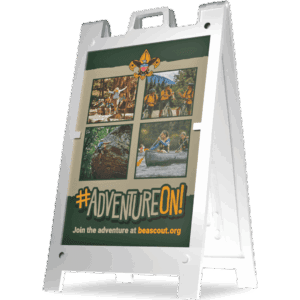 A sandwich board sign displays four photos of kids enjoying outdoor activities like hiking and canoeing, a Scout emblem, and the text #AdventureOn! Join the adventure at beascout.org.