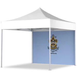 A white outdoor canopy tent with a blue back wall displaying the Sea Scouts logo, which features an anchor, a fleur-de-lis, and a ship’s wheel.