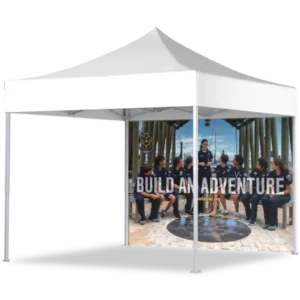 A white pop-up canopy tent with a printed back wall showing a group of people in scout uniforms sitting in a circle. The words BUILD AN ADVENTURE are displayed across the back wall image.