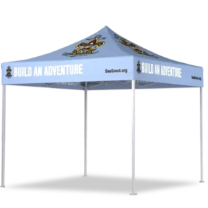 A light blue canopy tent with “BUILD AN ADVENTURE” in white text on all sides, featuring cartoon sea scout logos and the website SeaScout.org. The tent has four white legs.