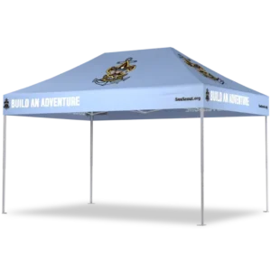 Light blue pop-up canopy tent with a cartoon sea scout logo and the phrase BUILD AN ADVENTURE printed on the side. The tent has four metal legs and the website SeaScout.org on the valance.