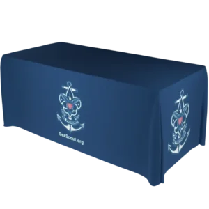 A navy blue tablecloth covers a rectangular table. The tablecloth features a white Sea Scouts emblem with an anchor and fleur-de-lis and the text SeaScout.org printed on the side.