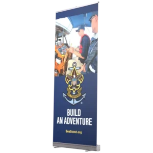 A banner with two people operating a boat, featuring the Sea Scouts logo and the text BUILD AN ADVENTURE SeaScout.org on a blue background.