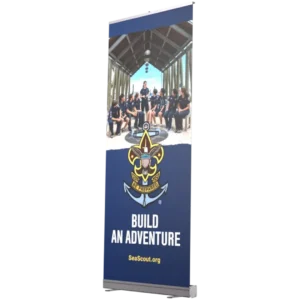 A vertical banner featuring a group of Sea Scouts in uniform sitting together under a pavilion, with the Sea Scouts logo and the words Build An Adventure and SeaScout.org below the image.