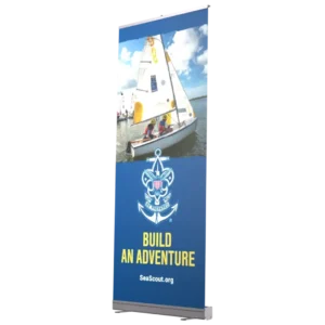 A promotional banner shows two people sailing a small boat on water under a blue sky. Below the image is the Sea Scouts logo and the text “Build an Adventure” with the website SeaScout.org.