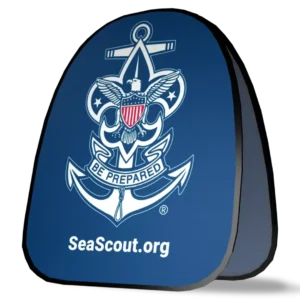 A blue triangle-shaped object featuring the Sea Scouts emblem with an eagle, shield, and anchor, the motto Be Prepared, and the website SeaScout.org in white text.