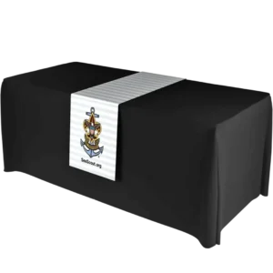 A black table with a white runner featuring the Sea Scouts logo—an anchor with the Boy Scouts emblem—draped over the center, and the text SeaScout.org below the logo.