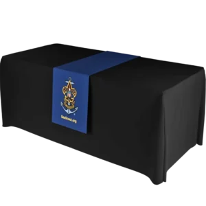 A black table with a blue table runner featuring the Sea Scouts logo and the text SeaScout.org in yellow.